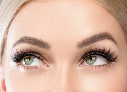 Photo of a woman's upper face and brows after a Brow Extensions Refill