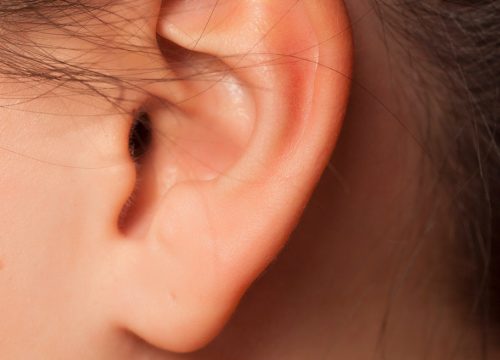 Photo of a woman's ear before ear waxing