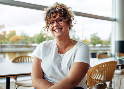 Portrait of a confident woman with eyeglasses in office.