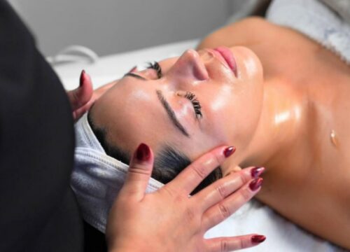 A close-up, high-angle shot of a client receiving a relaxing facial treatment at Lashiqué Studios.