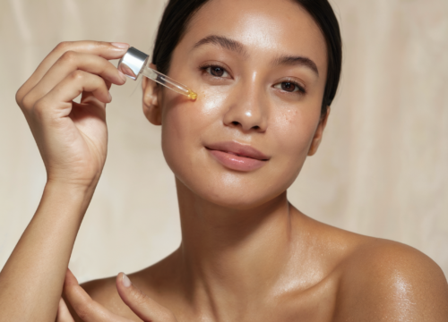 Close-up of a professional skincare serum being applied to the skin, representing peptide FAQs, collagen support, and skin barrier repair.
